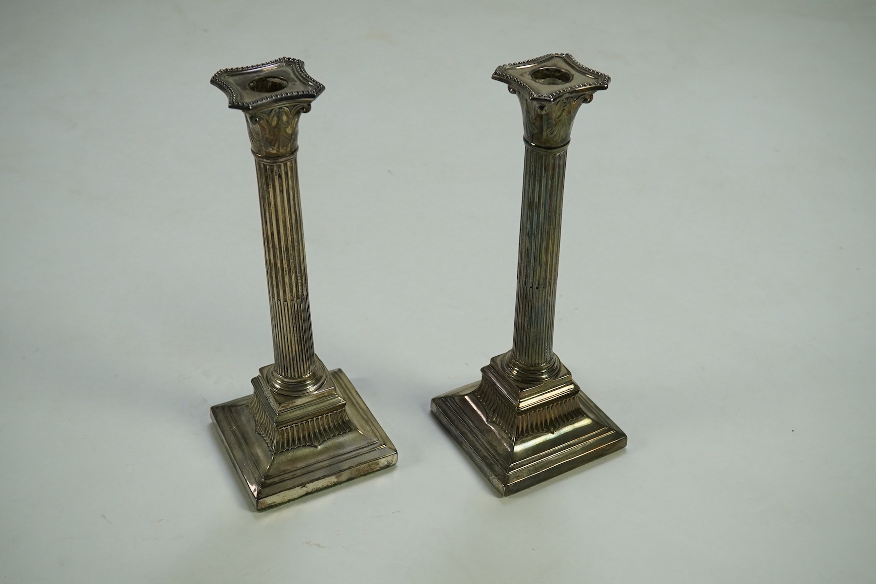 A pair of Victorian silver fluted column candlesticks, by Thomas Bradbury & Sons